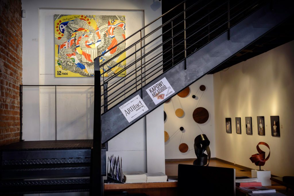Staircase and artwork at Anthony Brunelli Fine Arts.