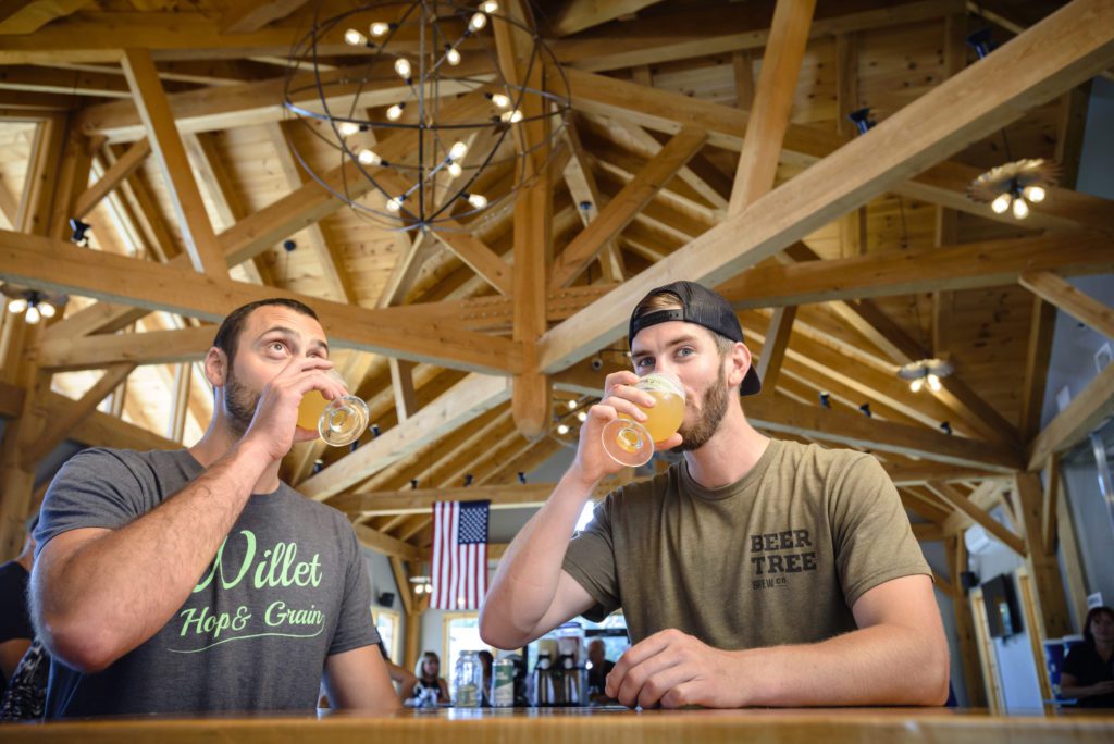 two men drinking craft beer at the brewery