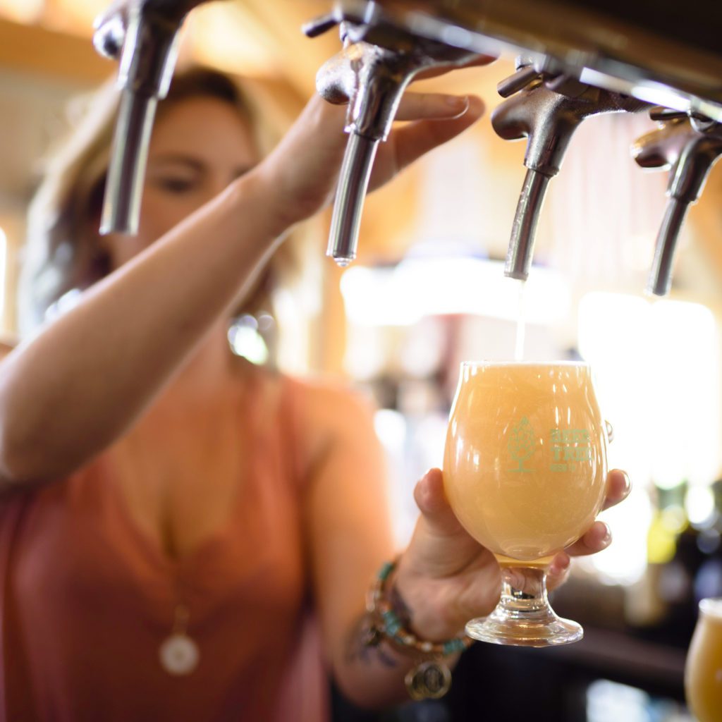 Woman pouring pint of beer
