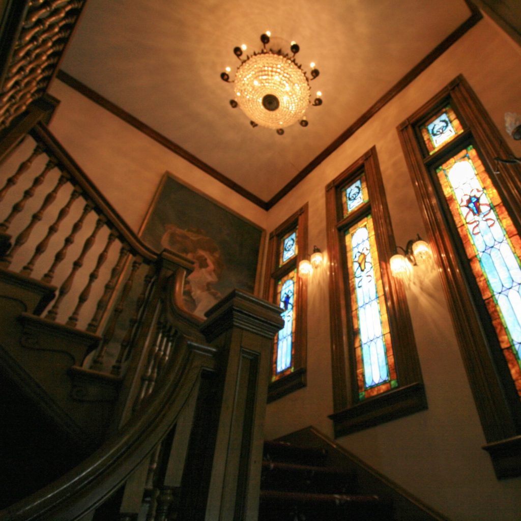 Staircase, windows and chandelier at the Bundy Museum of History and Art.