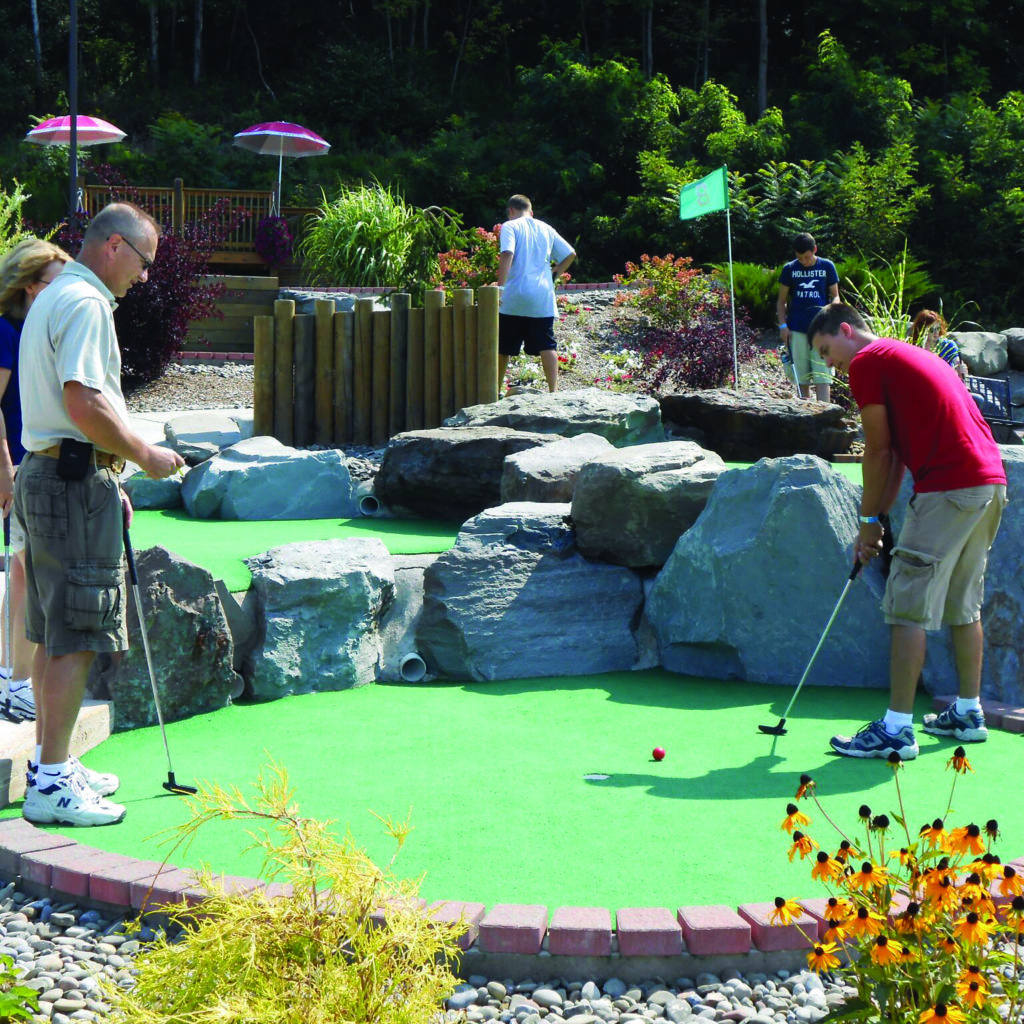 Two men playing miniature golf at Chuckster's.