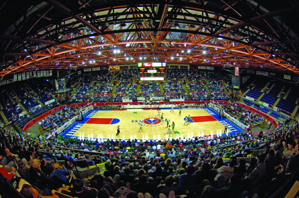 Basketball court in large arena.