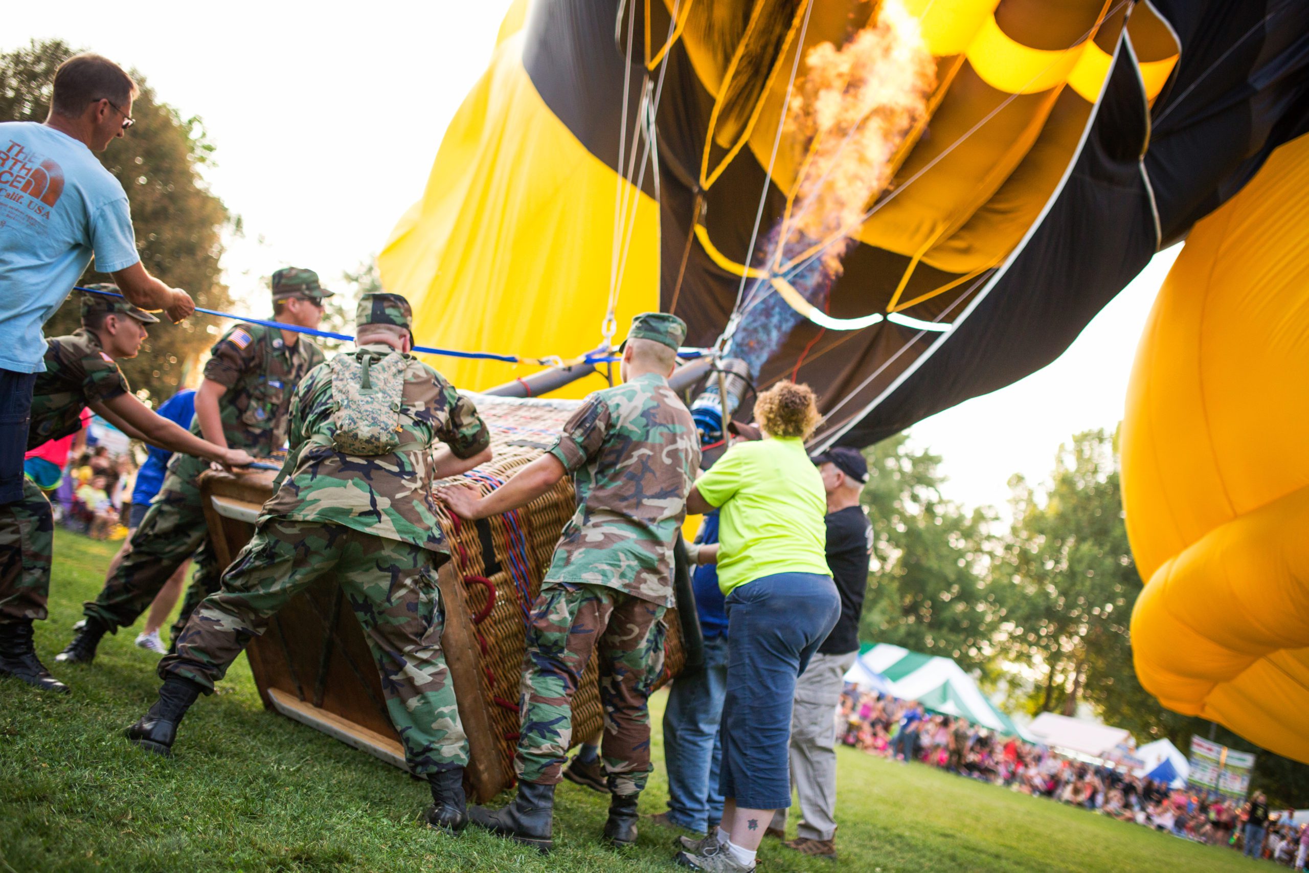 Military heating up hot air balloon  at outdoor festival