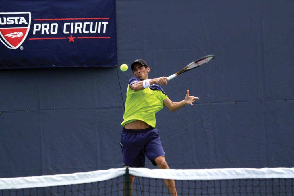 A tennis player just after hitting the ball.
